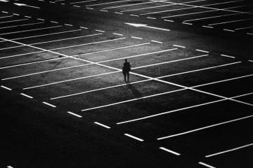 Man alone in carpark.