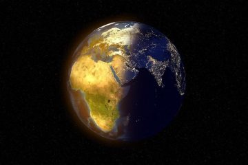 Satellite photo of the world: half in daytime, half in nighttime.
